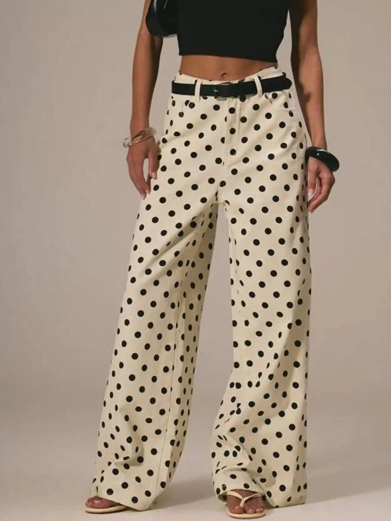 Person wearing polka dot pants with a plain background