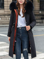 Lady wearing a black Women's Detachable Longline Hooded Parka with Faux Fur Trim and Drawstring Waist