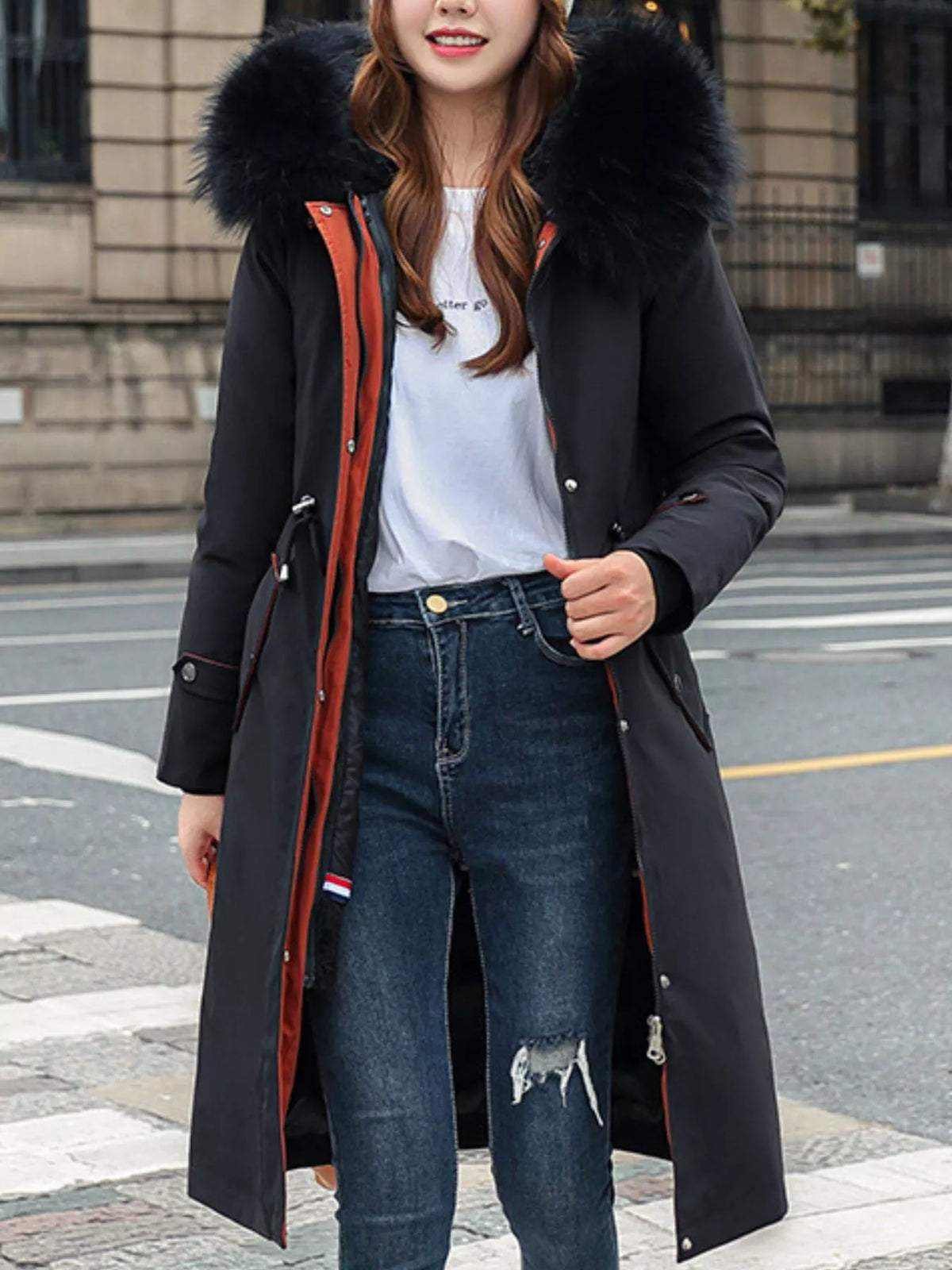 Lady wearing a black Women's Detachable Longline Hooded Parka with Faux Fur Trim and Drawstring Waist