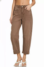 Brown jeans worn by a person on a white background