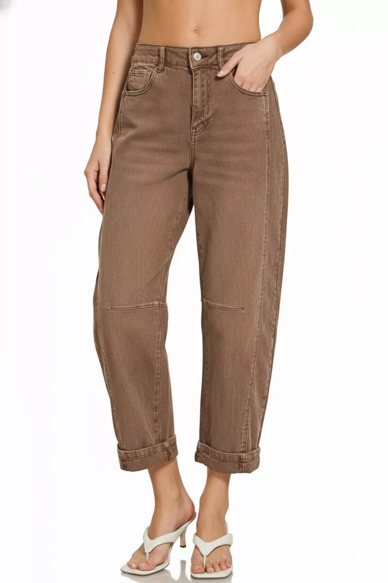 Brown jeans worn by a person on a white background