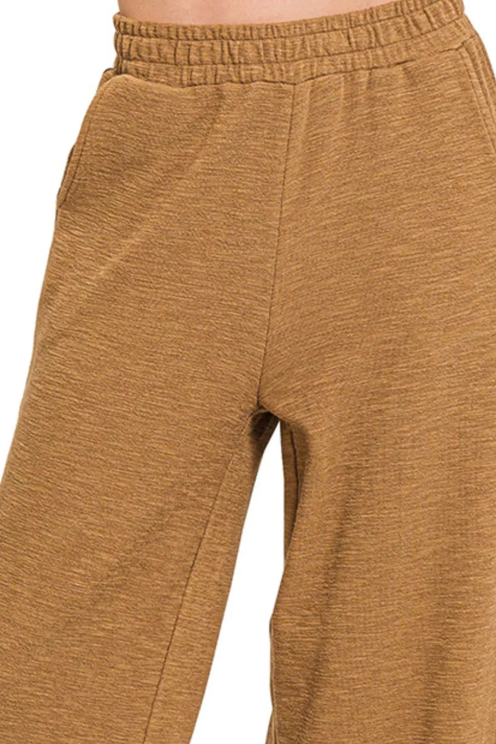 Close-up of brown pants on a white background