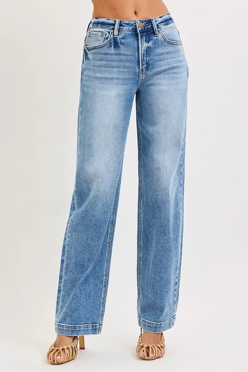 Blue jeans worn by a person on a light gray background