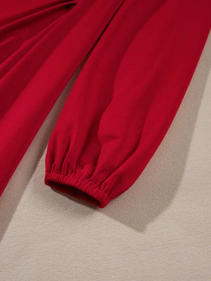 Red pants with elastic cuffs on a beige background