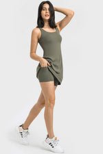 Woman wearing a green dress with white sneakers on a white background