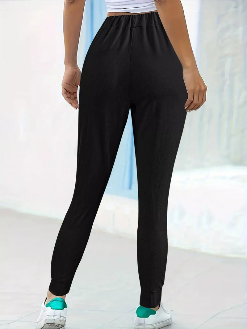 Person wearing black pants with a white background