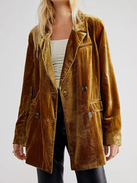 Brown velvet jacket worn by a person on a white background