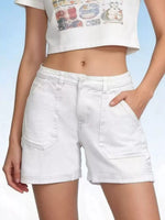 White denim shorts worn by a person on a light blue background