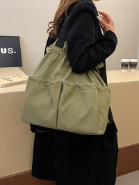 Person wearing a green tote bag in an indoor setting