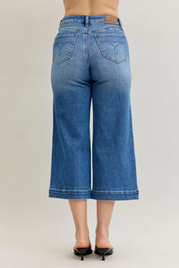 Blue denim wide-leg jeans on a plain background