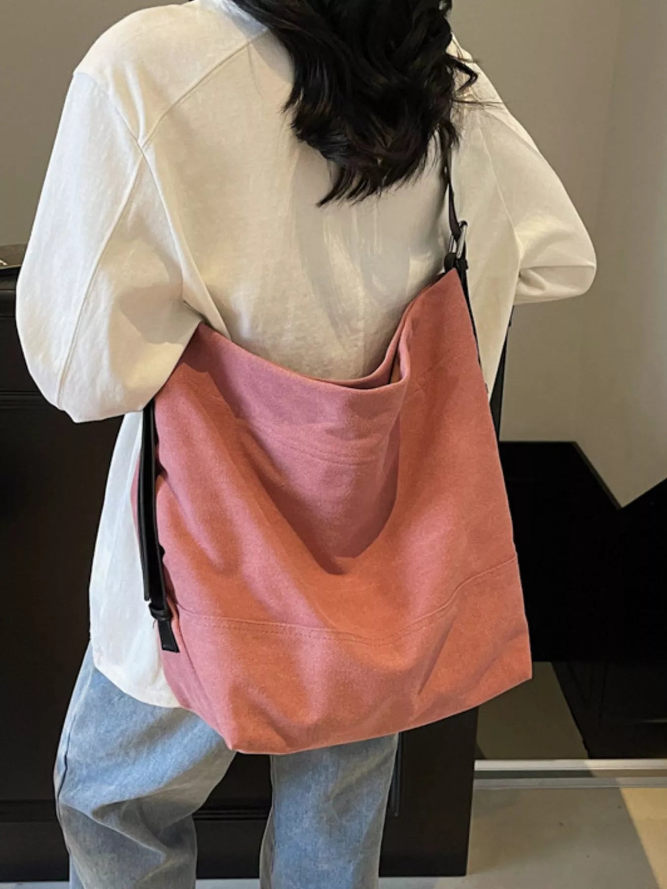 Person wearing a pink backpack with a neutral background
