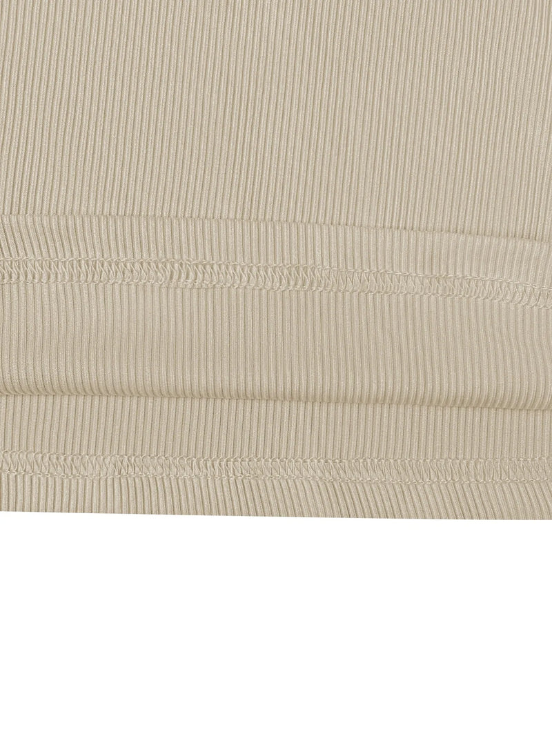 Close-up of beige ribbed fabric with visible stitching on a white background