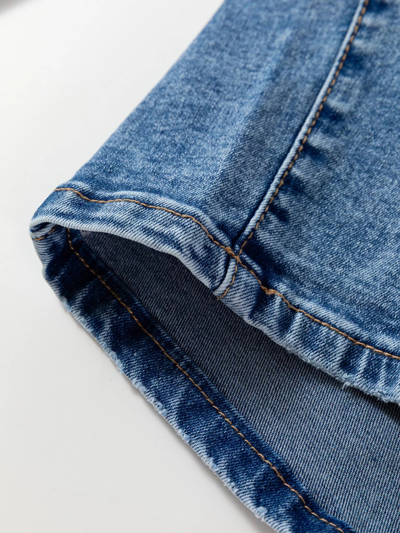 Close-up of blue denim fabric on a white background