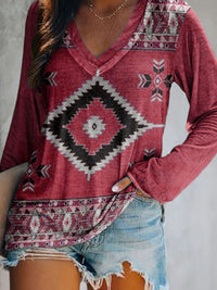 Red patterned top worn by a person with a neutral background