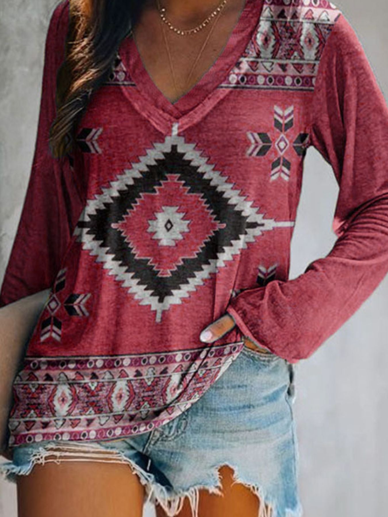 Red patterned top worn by a person with a neutral background