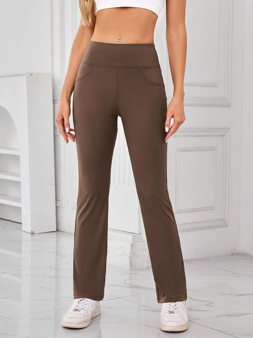 Brown pants worn by a person in a minimalistic indoor setting