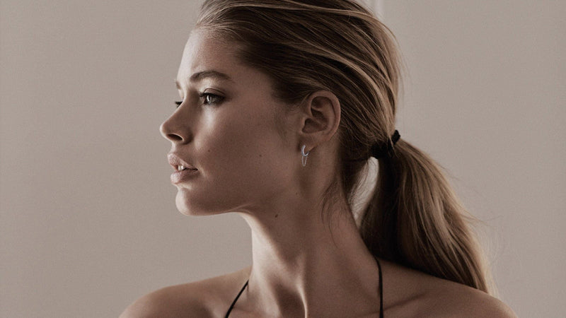 Model showing 12.5Mm Diamond And White 14K Gold Huggies With Chain in left hair