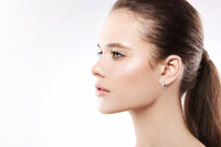 Model wearing 12.5Mm Diamond And White 14K Gold Huggies With Chain