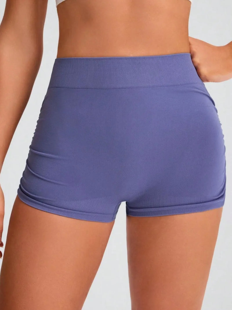 Purple athletic shorts worn by a person on a plain background