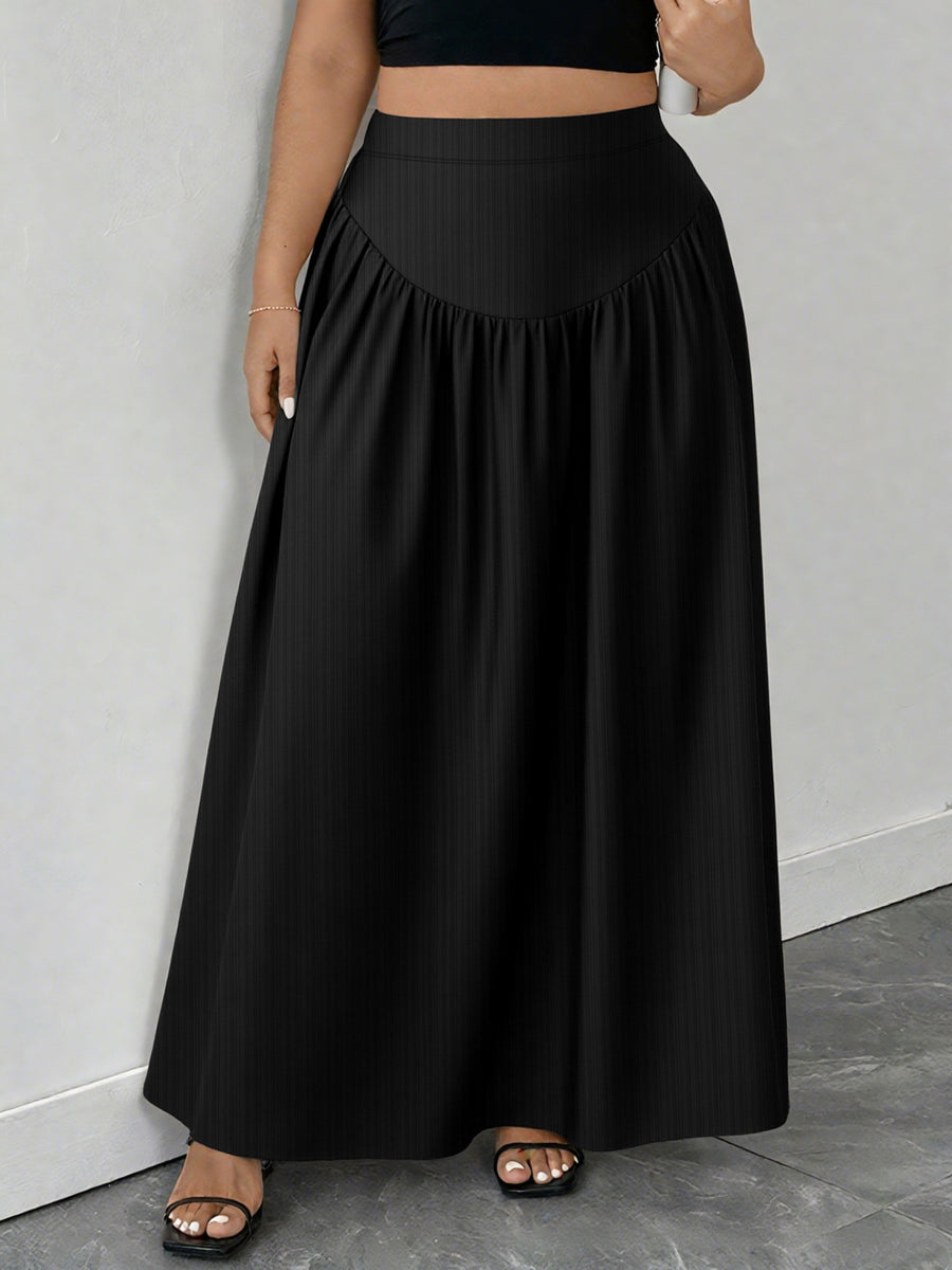 Person wearing a black skirt and black top against a gray background