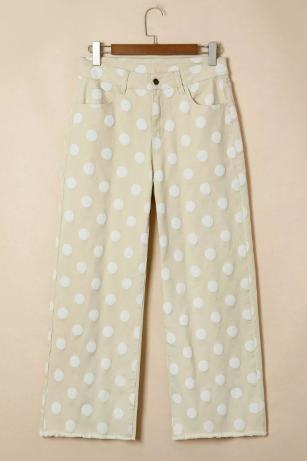 Beige pants with white polka dots on a beige background