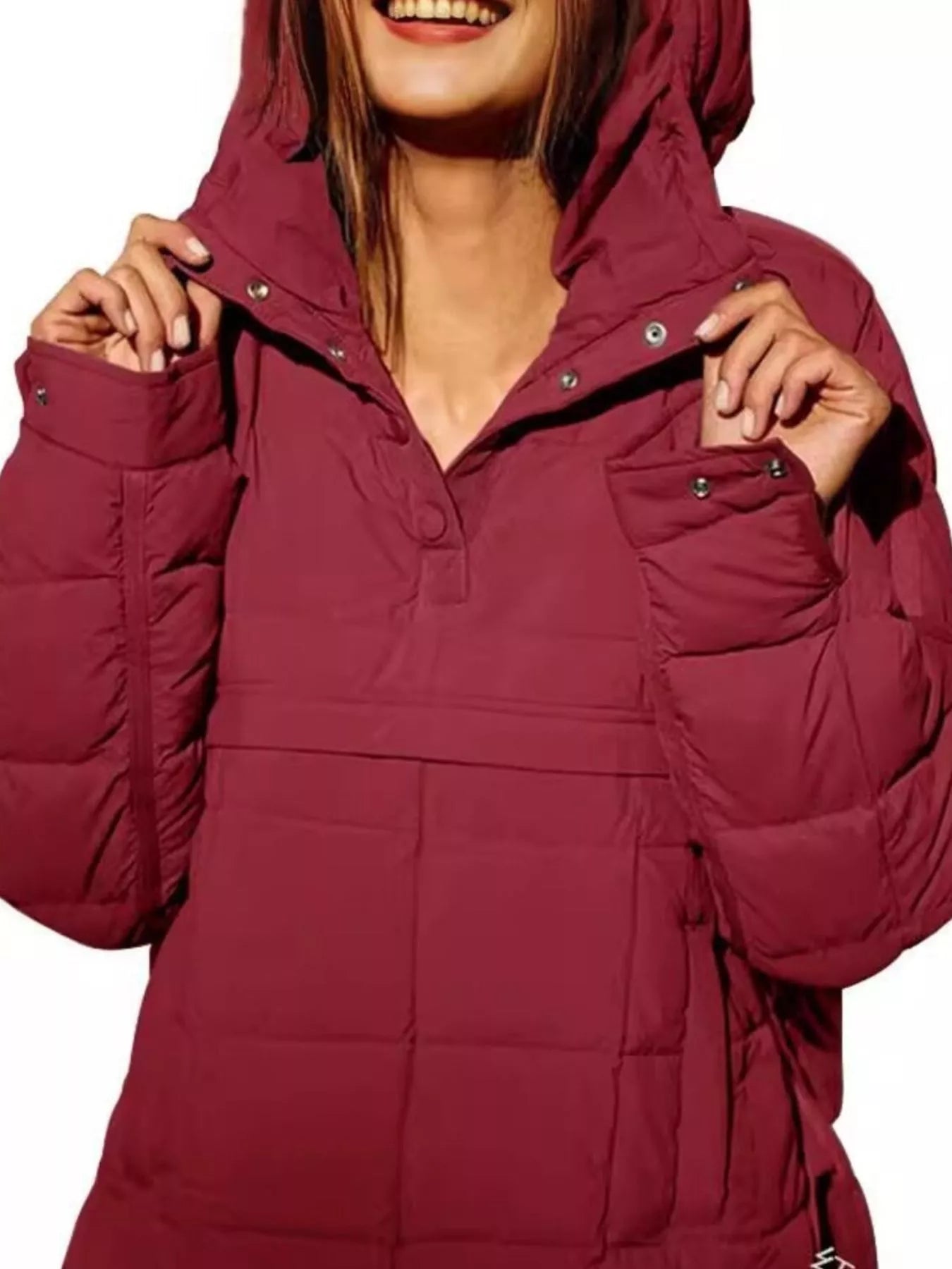 Person wearing a maroon hooded jacket on a white background