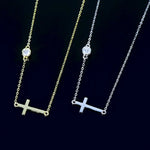 Two necklaces with cross pendants on a black background