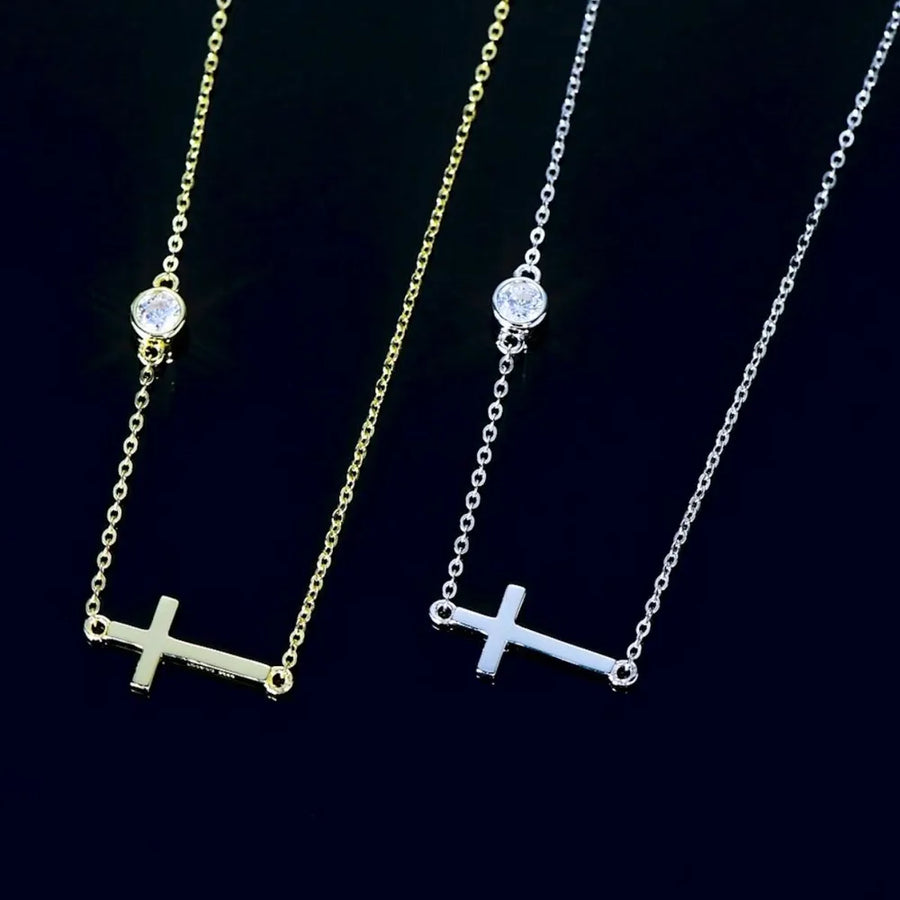Two necklaces with cross pendants on a black background