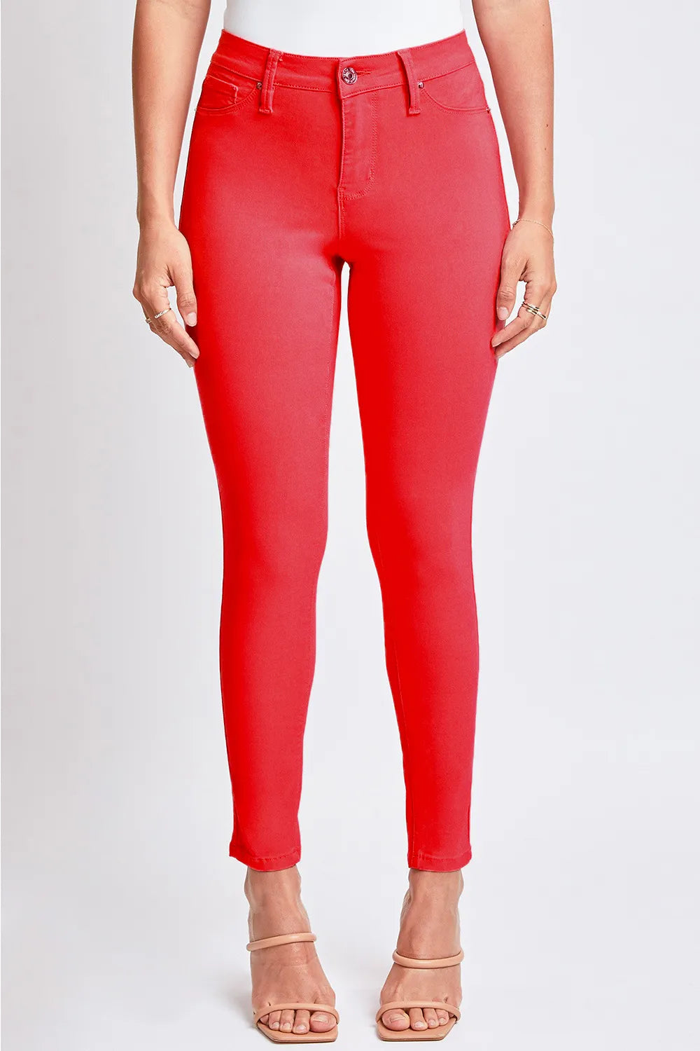 Red jeans worn by a person on a white background