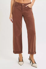 Brown pants worn by a person on a white background
