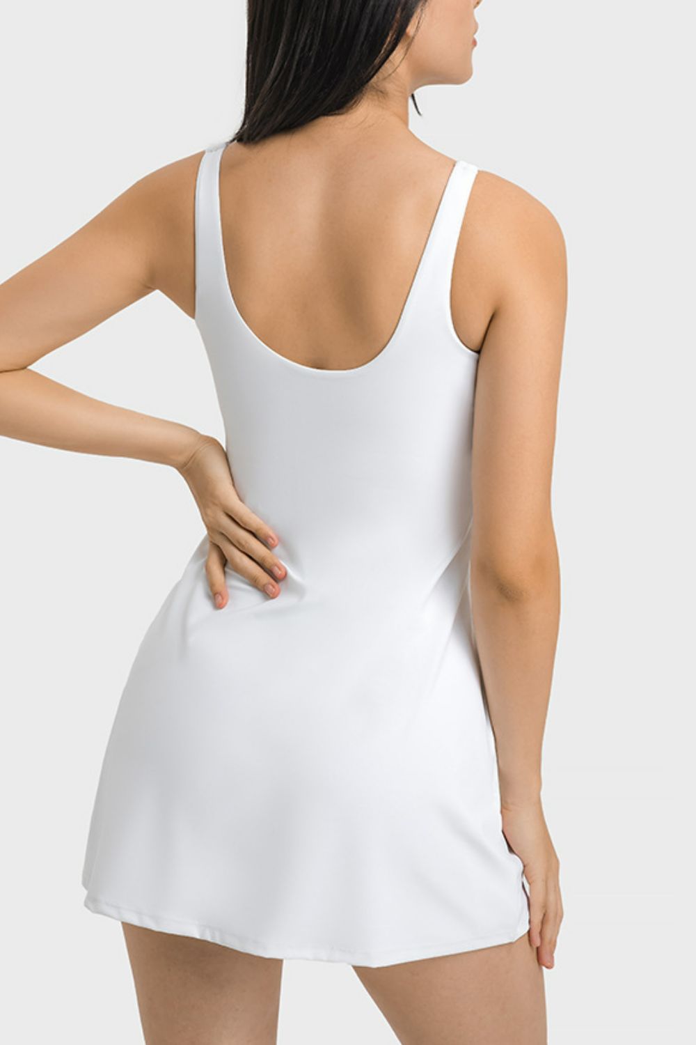 White dress worn by a model on a plain background
