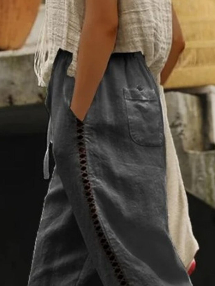 Person wearing a long, dark-colored skirt with a blurred background