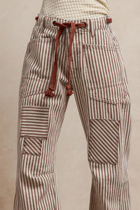 Striped pants with a drawstring on a beige background