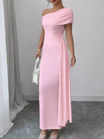 Woman wearing a pink one-shoulder dress in an indoor setting.