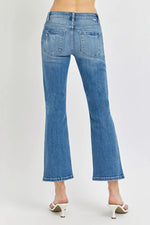 Blue jeans worn by a person on a white background