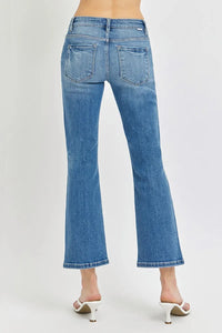 Blue jeans worn by a person on a white background