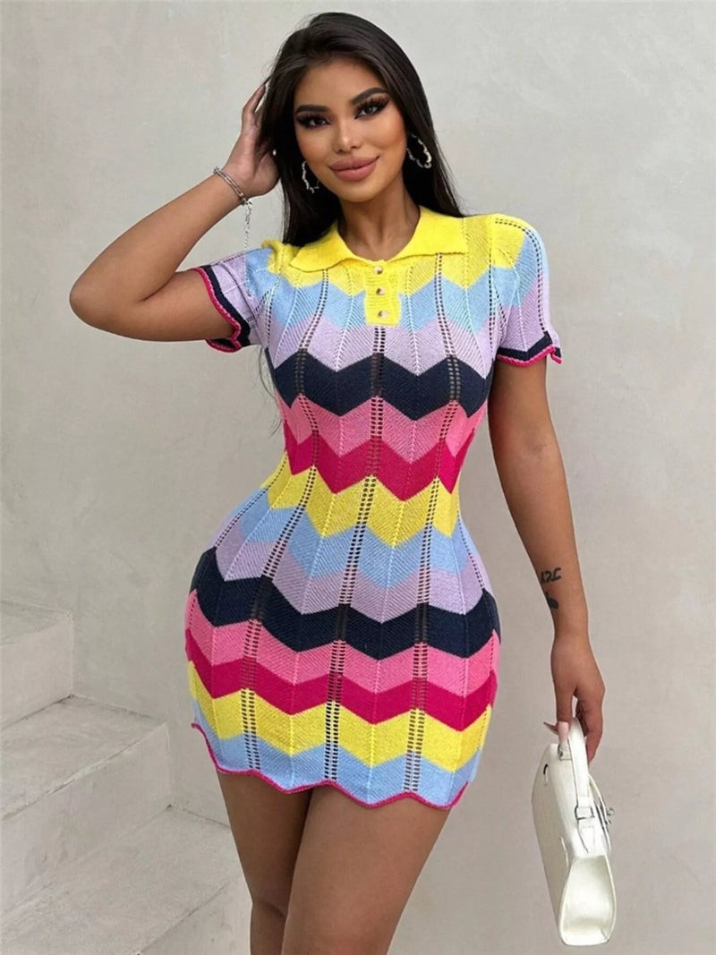Woman wearing a colorful striped dress against a plain background