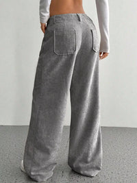 Gray corduroy wide-leg pants worn by a person on a plain background