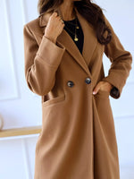 Brown coat worn by a person with a blurred background