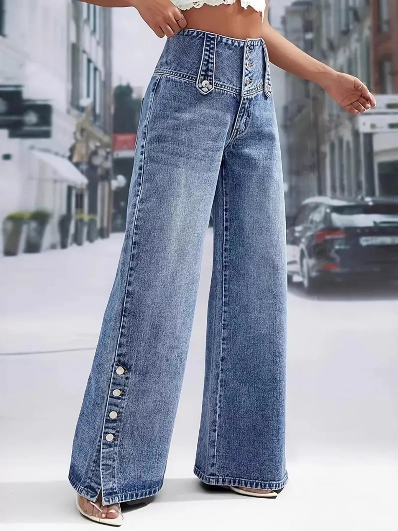 Person wearing high-waisted blue jeans on a city street.