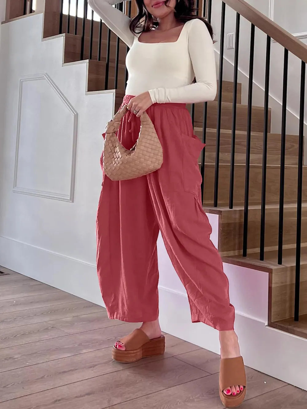 Woman in a house wearing baggy pants
