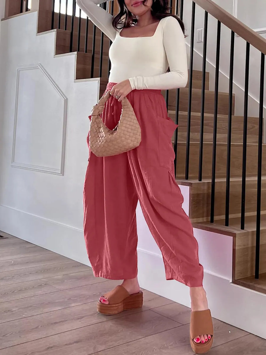 Woman in a house wearing baggy pants