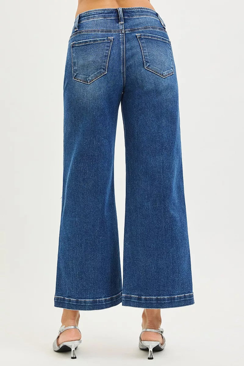 Blue jeans worn by a person on a white background