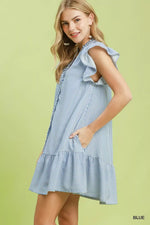 Woman wearing a blue and white striped dress on a green background