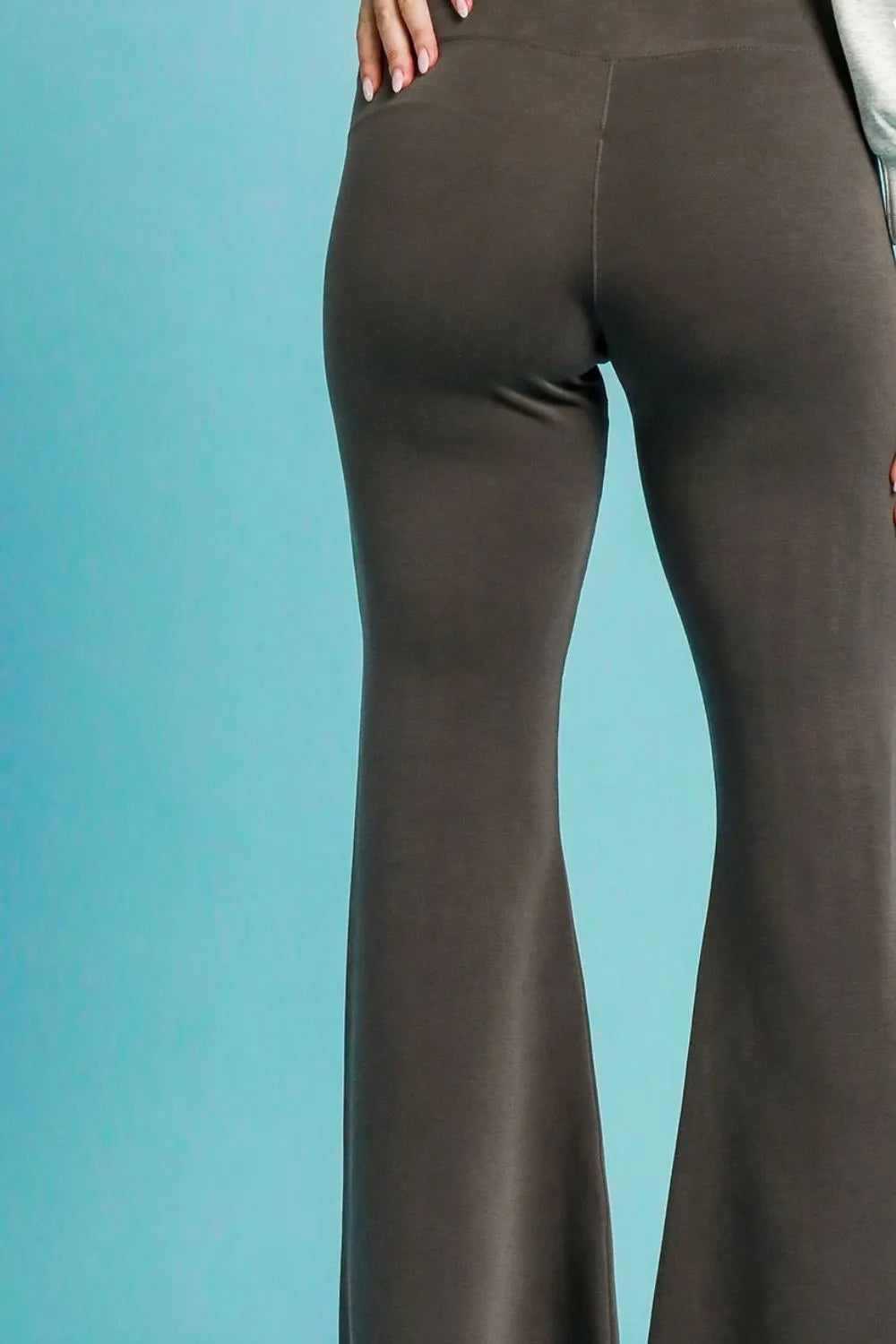 Brown flared pants on a blue background