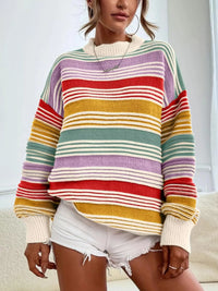 Person wearing a colorful striped sweater with a neutral background