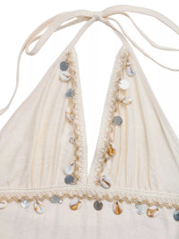 Beige bikini top with shell embellishments on a white background