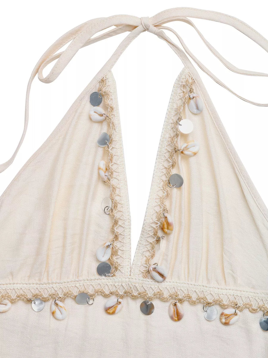Beige bikini top with shell embellishments on a white background