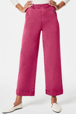 Pink wide-leg pants worn by a person on a white background