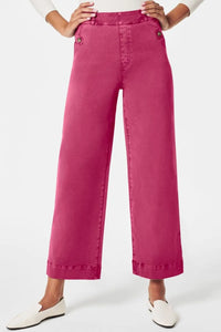 Pink wide-leg pants worn by a person on a white background